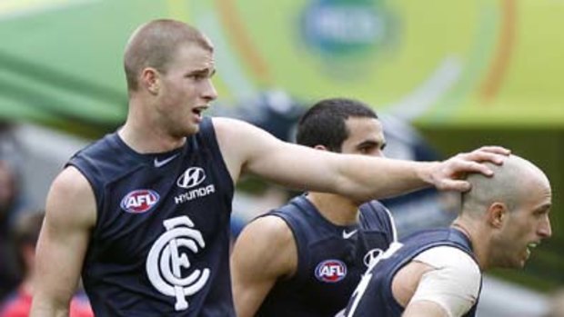 Lachlan Henderson pats captain Chris Judd on the head.