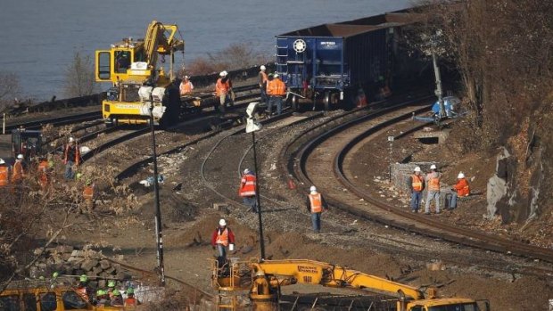 Workers busy on the tracks of the Metro-North train derailment in the Bronx borough of New York. 