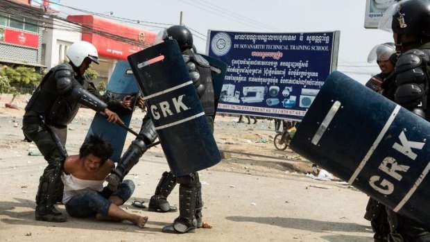 A man is arrested during a demonstration on January 3, 2014 in Phnom Penh, Cambodia.