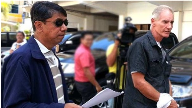 Peter Gerard Scully is escorted to court by agents of the Philippines National Bureau of Investigation before his incarceration at  Barangay Lumbia on Tuesday.