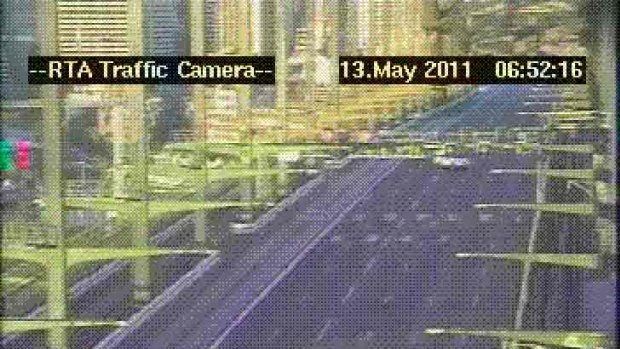 Protest on the Harbour Bridge ... police wait for the protester to abseil down from the bridge.