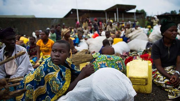 Under threat ... internally displaced Congolese sit inside a United Nations base outside Goma, seeking shelter after being forced to flee.