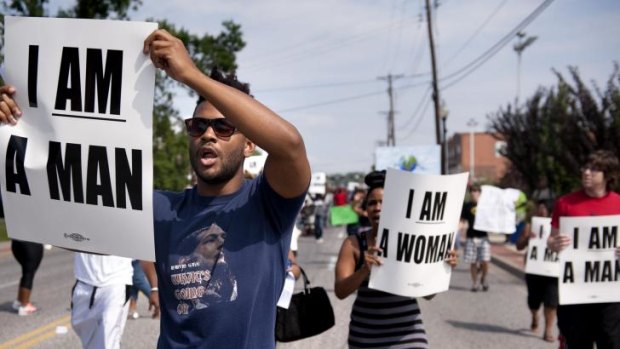 Protesters holding civil rights era slogans in St Louis after Michael Brown's shooting.