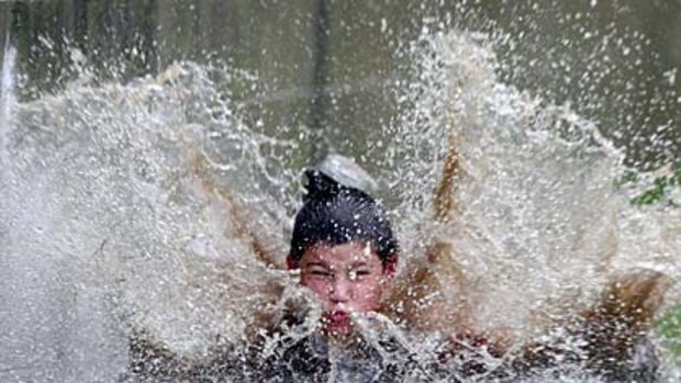 Surf on turf... Joseph Vasilis, 10, makes a splash at Coogee Oval providing half time entertainment for rugby fans there to watch Randwick play West Harbour.