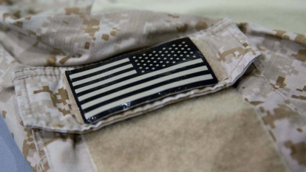 A detail of the fatigue shirt showing an American flag emblem.