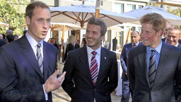 Britain's Princes William, left, and Harry, right, pictured with David Beckham in Johannesburg.