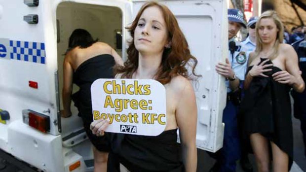 Police detain PETA demonstrators outside a fast-food outlet in central Sydney.