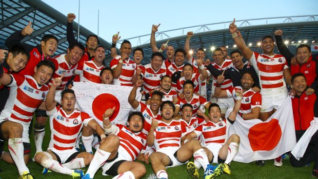 Cherry Blossoms in bloom: Japan players celebrate after defeating South Africa.