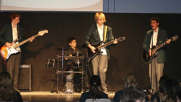 High school and musical ... Michael, second right, and Calum, right, perform with fellow students at Norwest Christian College.