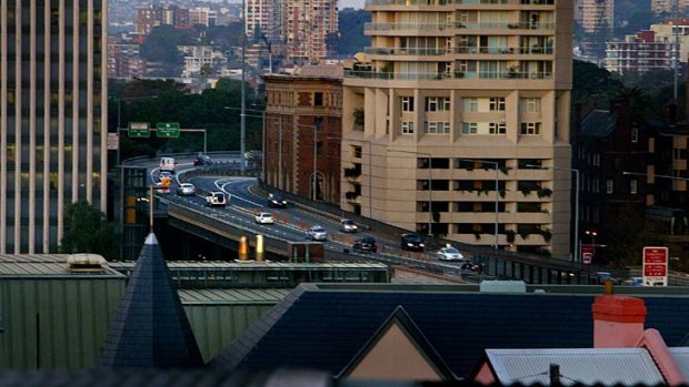Traffic passes over the Cahill Expressway at dusk.