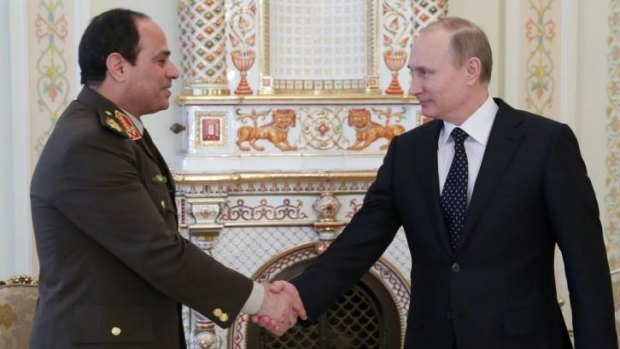 Russian President Vladimir Putin, right, shakes hands with Egypt's Military chief Field Marshal Abdel-Fattah al-Sisi. 