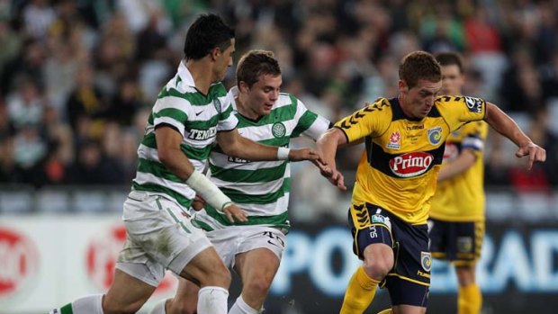 Catch me if you can ... the Mariners' Oliver Bozanic keeps possession of the ball during their friendly match against  Celtic at ANZ Stadium last night.