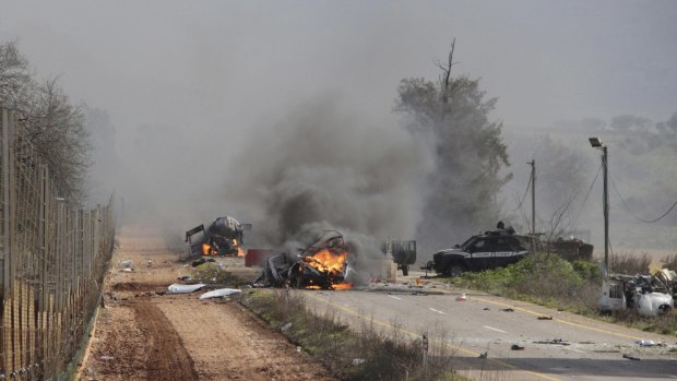 Burning vehicles are seen near the village of Ghajar on Israel's border with Lebanon. A Hezbollah missile strike killed two and wounded seven Israeli soldiers on Wednesday.