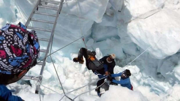 Nepalese rescue team members help a survivor of the avalanche.