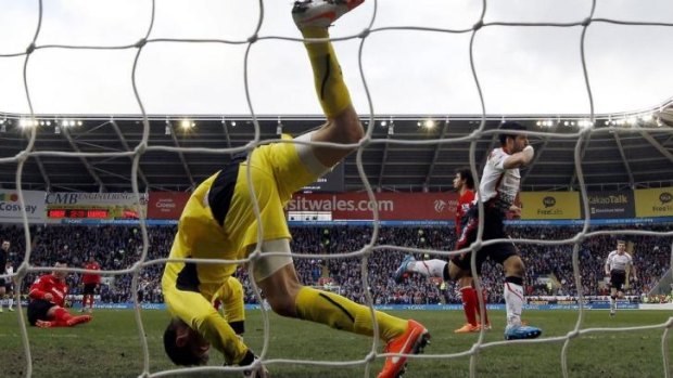 Luis Suarez of Liverpool bamboozles Cardiff City's goalkeeper David Marshall 