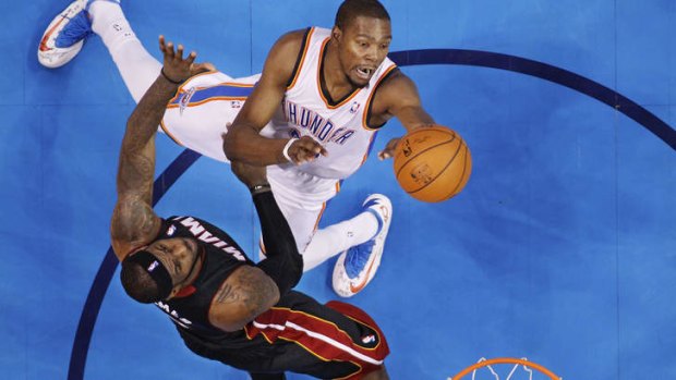 Oklahoma City Thunder forward Kevin Durant shoots in front of Miami Heat rival LeBron James in Oklahoma City. Miami won 103-81.