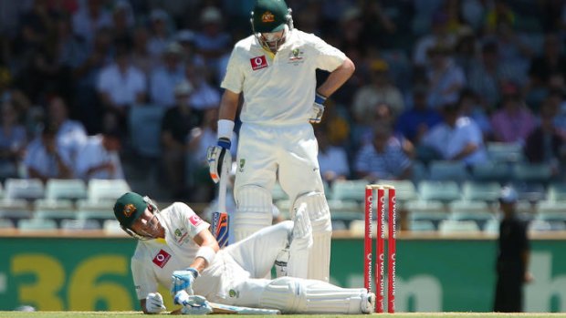 Michael Clarke is felled by a ball to the groin as Michael Hussey looks on during the third Test against South Africa.
