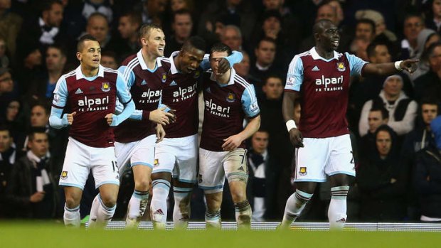 Moving on: West Ham players celebrate their victory over Tottenham.