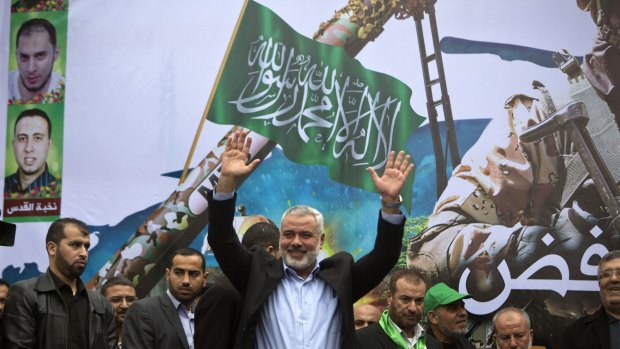 Gaza Hamas leader Ismail Haniya greets supporters during a rally to commemorate the 27th anniversary of the Islamist movement's creation.