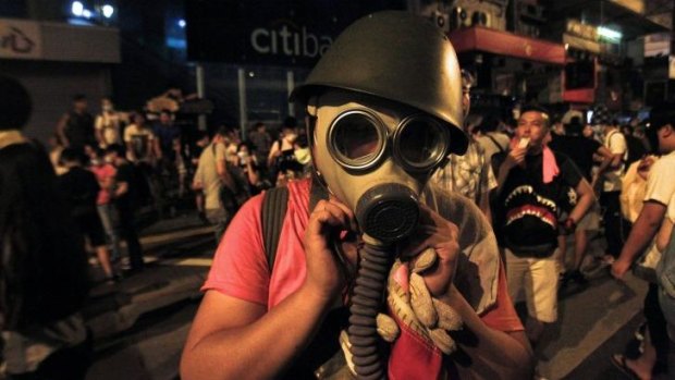 A protester puts on a gas mask to prepare for a possible tear-gas attack by police in Hong Kong.