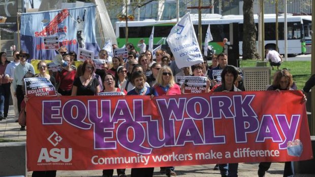 Long march ... community workers rally for equal pay in Canberra last September.