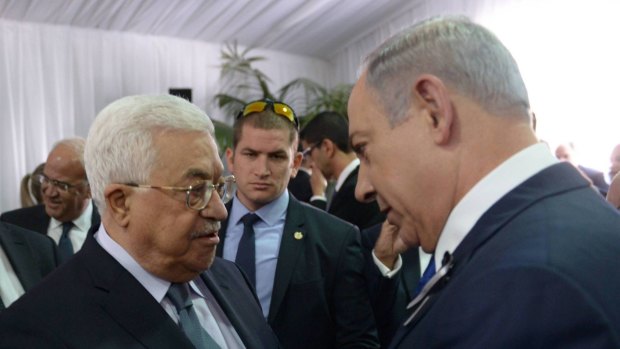 Israeli Prime Minister Benjamin Netanyahu shakes hands with Palestinian Authority president Mahmoud Abbas during the funeral of former Israeli leader Shimon Peres.