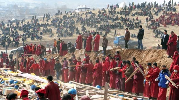 Sombre ... Tibetan monks prepare the pyre for the mass cremation.