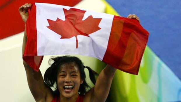 Carol Huynh of Canada celebrates after winning the gold medal at the Beijing Olympics. Women's wrestling will make its Commonwealth Games debut in Delhi.