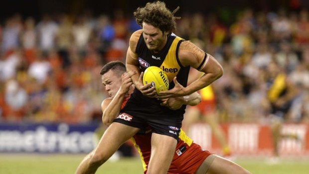Tiger Ty Vickery pressured by the Suns' defence in round one at Metricon Stadium.