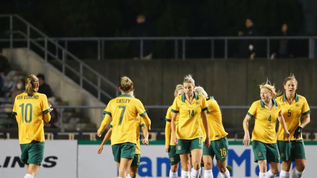 Two's company: Michelle Heyman (third from right) celebrates scoring the Matildas' second goal in the 3-1 win over Japan.