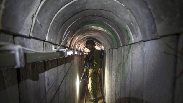 Subterranean threat: An Israeli soldier gives journalists a tour of a tunnel allegedly used by Palestinian militants for attacks from the Gaza Strip.