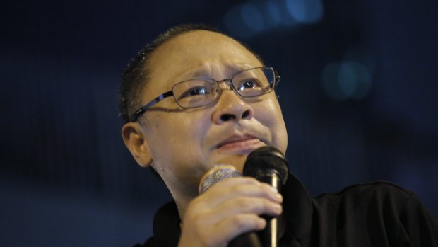 Founder of the Occupy Central civil disobedience movement Benny Tai cries during a rally outside government headquarters after protesters were threatened by residents and pro-Beijing supporters.