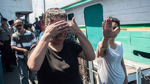 Journey cut short: Asylum seekers are taken off a boat in Bali. Authorities are trying to determine their nationalities.