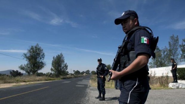 Policemen stand guard in front of the National Institute for Nuclear Research (ININ) in Mexico, where a truck transporting a "teletherapy source" containing cobalt-60 was stolen by gunmen.