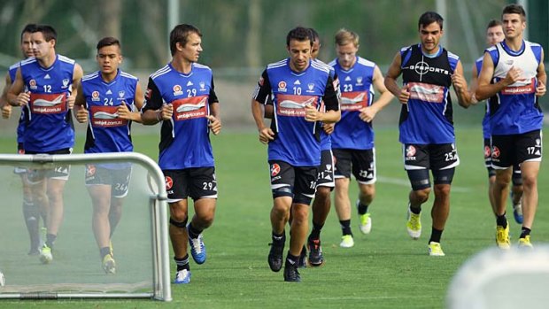Sidelined &#8230; star striker Joel Griffiths, left of centre, trains with Sydney FC teammates on Tuesday morning.