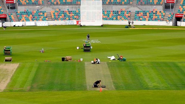 Groundsmen prepare the pitch for today's second Test in Hobart.