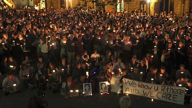 Concerned citizens light candles at Town Hall for the children and families being held indefinitely on Manus Island.