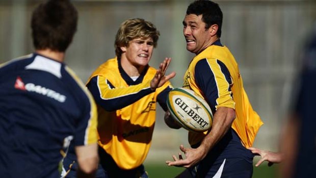 Cameron Shepherd offloads the ball during a Wallabies training session at Coogee Oval yesterday.