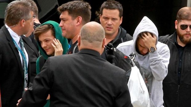 Louis Tomlinson in green and Liam Payne in grey from One Direction arrive in Sydney.