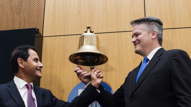 Medibank managing director George Savvides and Finance Minister Mathias Cormann at the ASX Medibank private listing ceremony. 