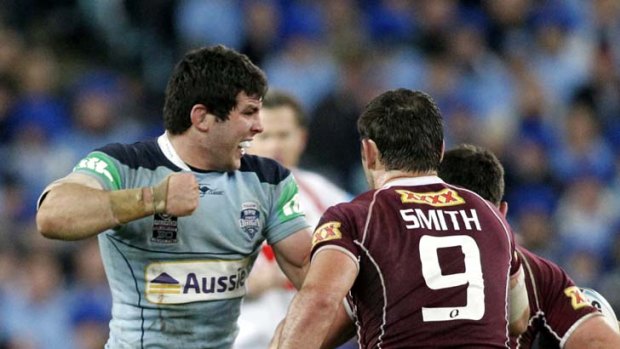 No surrender ... Michael Ennis throws a punch at Nate Myles during Origin III 2010 .