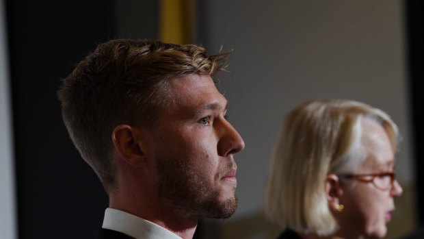 Glory spoilt: Richmond president Peggy O'Neal faces the glare of a hostile media alongside player Nathan Broad. 