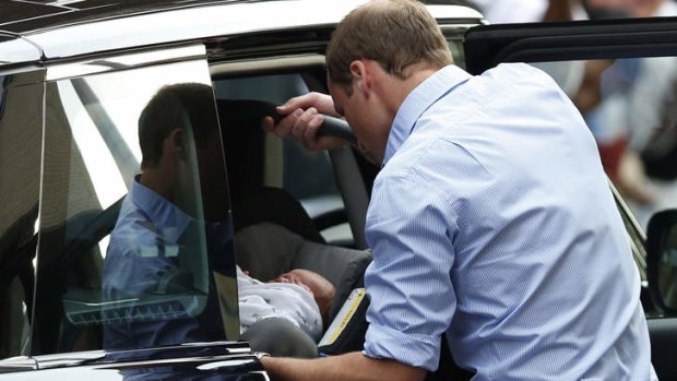 Baby's first throne...Prince William places Baby Cambridge into the car before driving off.