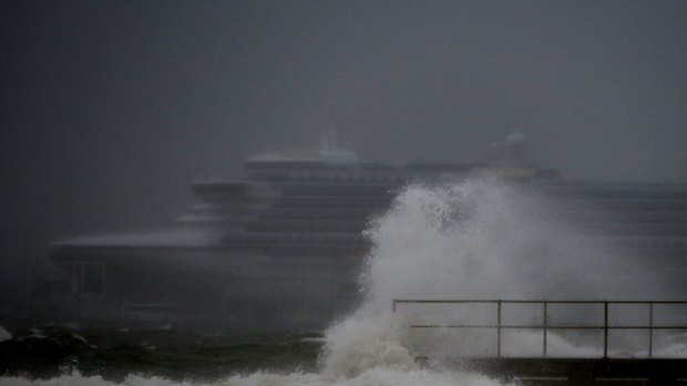 Large waves break on Port Phillip Bay on Monday morning as a cruise ship is docked in Port Melbourne.