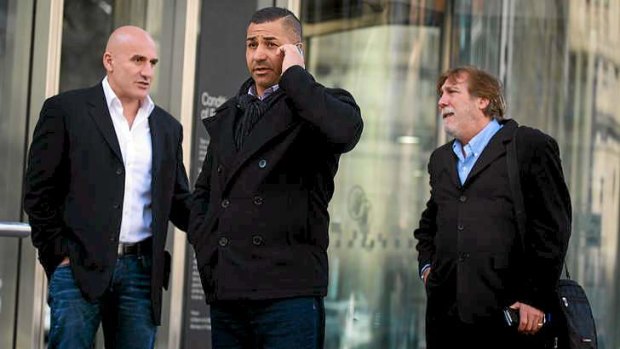 John Elias (far left), Kamal Tamer and George Grotta outside Melbourne County Court on Wednesday.