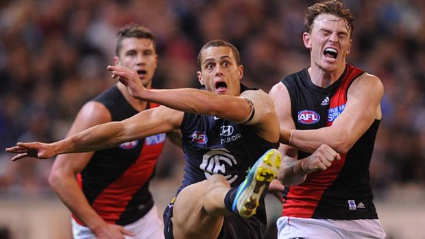 Crunch: Essendon's Brendon Goddard crashes into Carlton's Ed Curnow as he gets a kick away at the MCG on Saturday night.