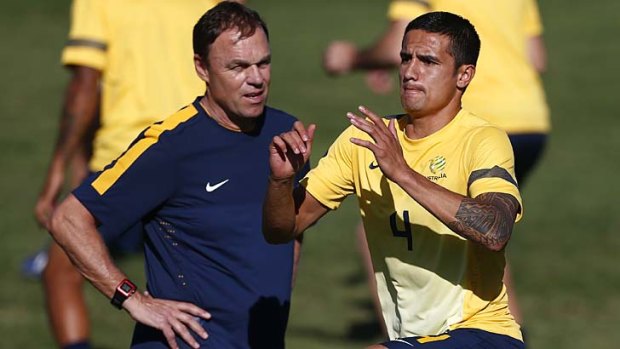 Socceroos coach Holger Osieck and Tim Cahill during a training session on Monday.