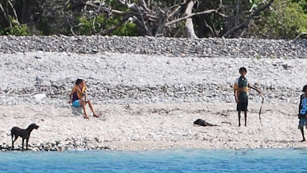 The goat lays on the beach after the beating.