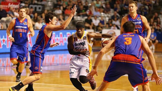 Jonny Flynn of the Tigers moves through a pack of Adelaide players during the round 18 NBL match on Sunday.