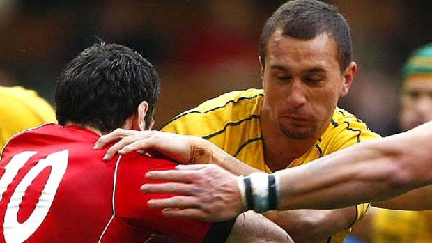 Pivotal figure . . . Quade Cooper takes the ball into contact against Wales.